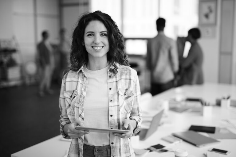 Cheerful Young Woman Posing in Creative Agency