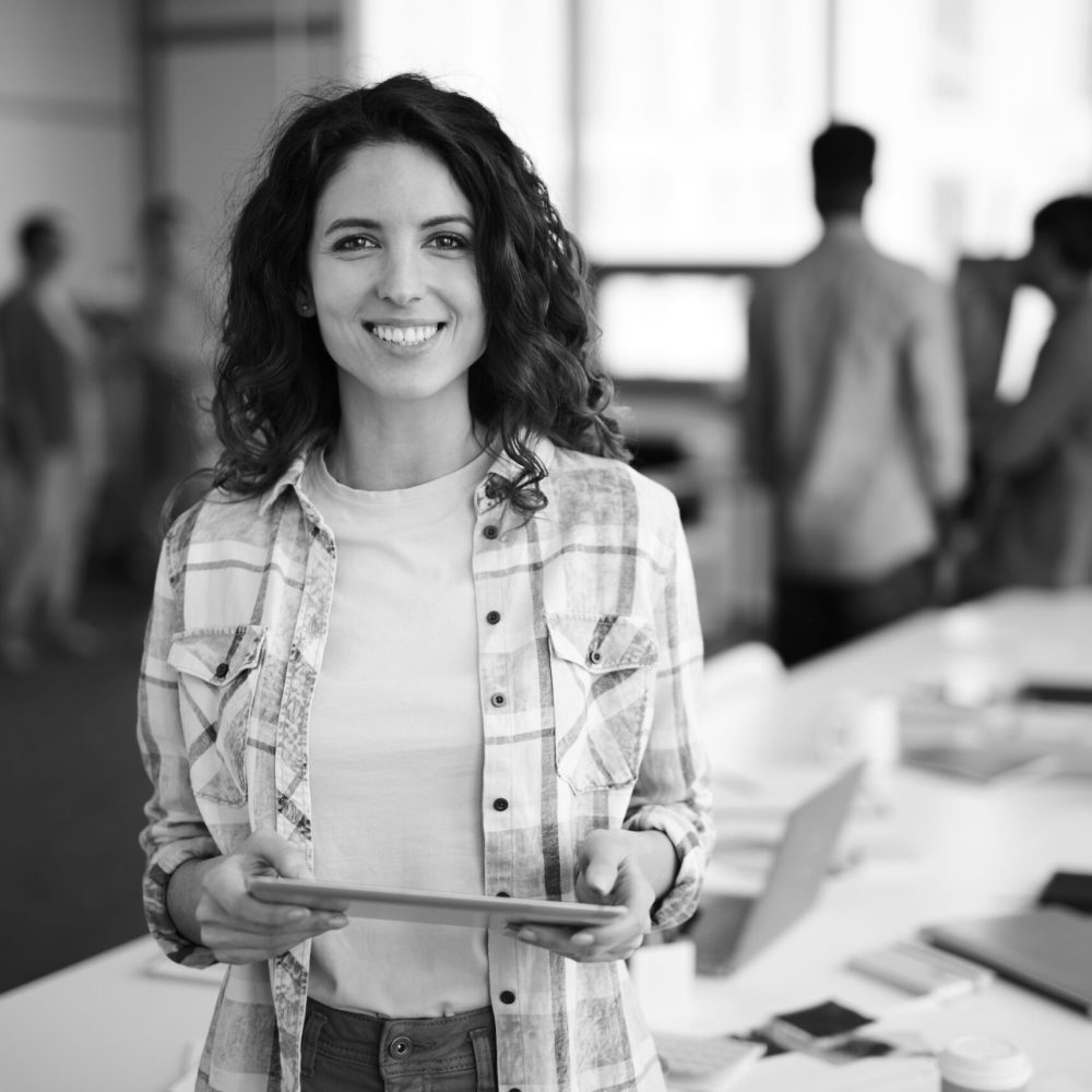 Cheerful Young Woman Posing in Creative Agency